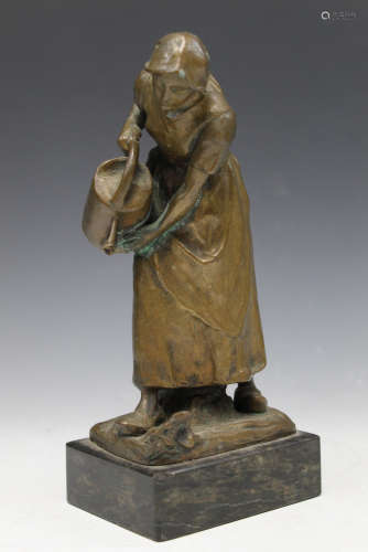 Bronze statue of a lady watering flower.