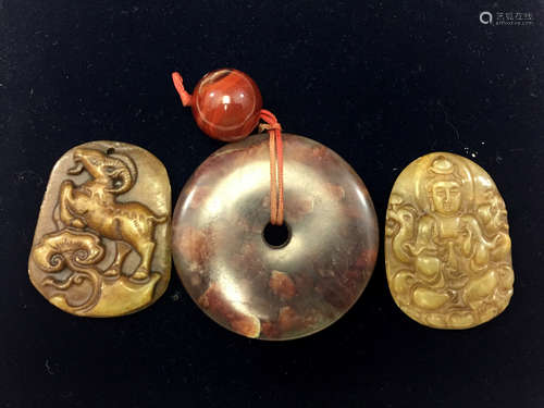 Three Chinese carved jade pendants.