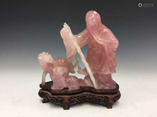 Chinese carved rose quartz figure on wood stand.