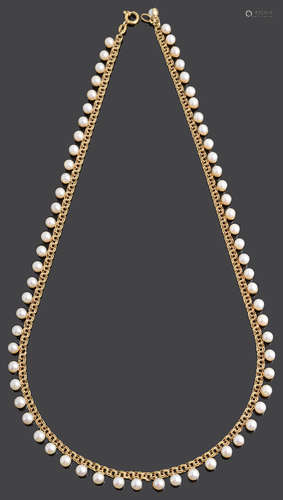 A delicate cultured pearl drop choker necklace