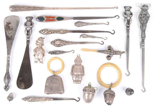 A collection of silver belt hooks, novelty rattles etc.