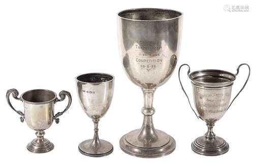 An Edwardian large silver trophy cup and three others