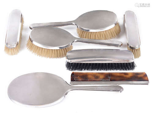 A George VI late Art Deco engine turned silver backed six piece dressing table set