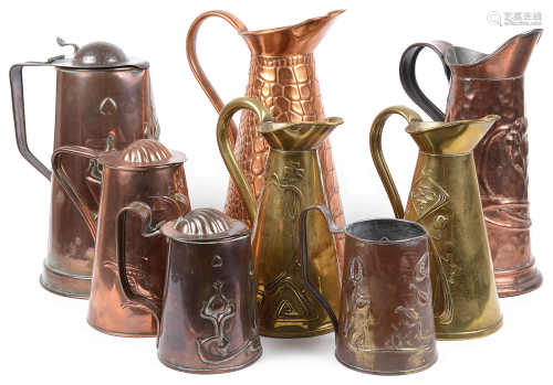 A collection of eight Arts and Crafts mostly Joseph Sankey & Son copper and brass ewers and jugs