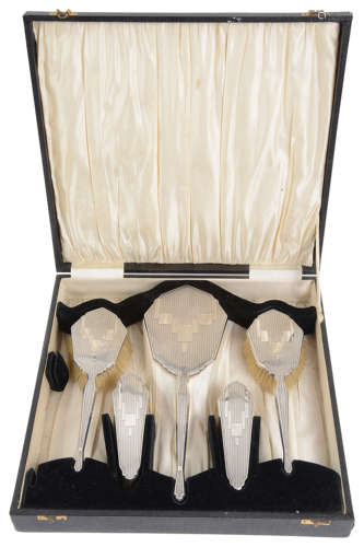 A George V Art Deco silver backed five piece dressing table set