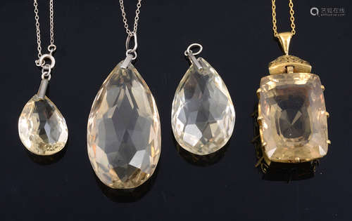 A large rectangular cushion cut citrine pendant and three other citrine pendants