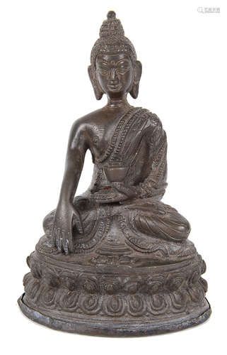 An antique Nepalese small bronze buddha