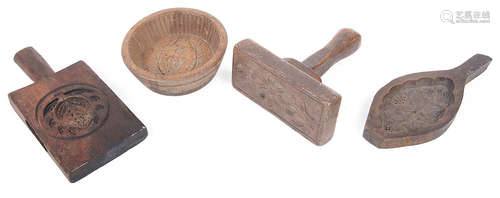 A collection of treen butter moulds and pats