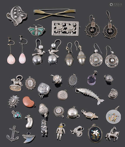 An interesting collection of Victorian silver earrings and a selection of mainly silver charms