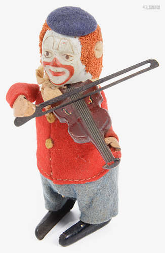 A 1930s Schuco clockwork tinplate violin playing dancing clown