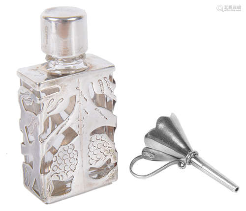 A contemporary silver caged glass scent bottle