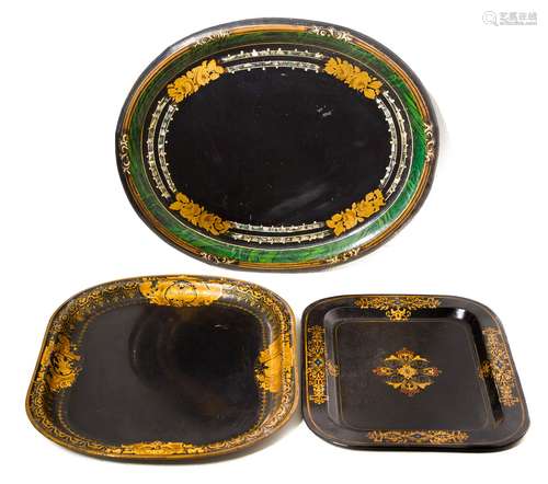 Three decorated laquered tin trays, with golden and pearl decorations. Cm 42, cm 38, cm 30