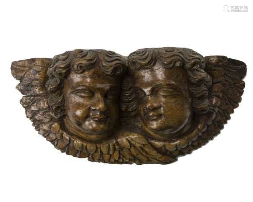 A carved wood cupid corbel