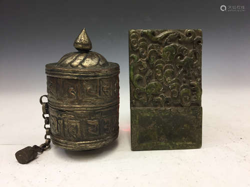 Tibetan metal prayer's wheel and jade amulet.