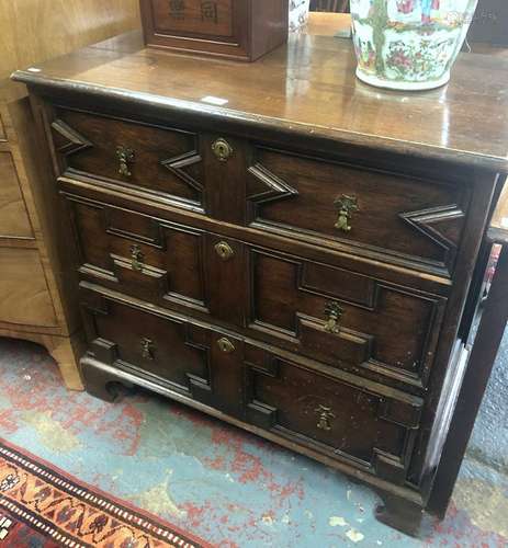 An antique joint oak Jacobean style chest of three long graduated drawers