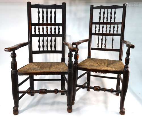 Two 19th century Lancashire oak/elm spindle-back rush seated open armchairs