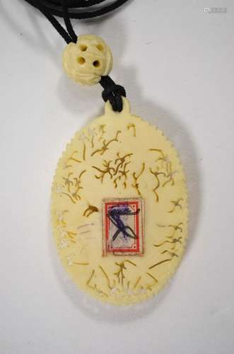 An early 20th century Japanese carved ivory floral pendant