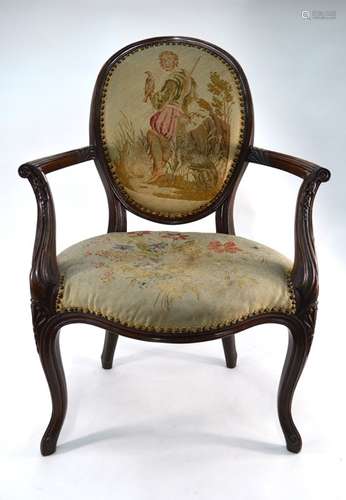 An antique French walnut framed open arm salon chair