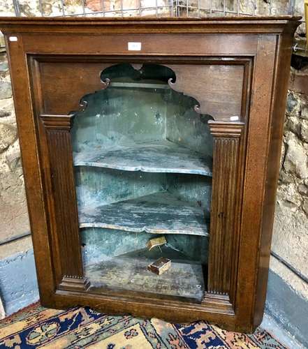 An 18th century continental oak hanging corner cabinet