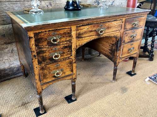 A Victorian Aesthetic period leather top knee-hole desk, presented in distressed/part stripped finis