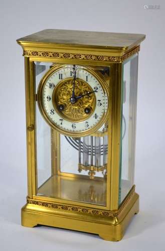 A late 19th century lacquered brass four window eight-day mantel clock