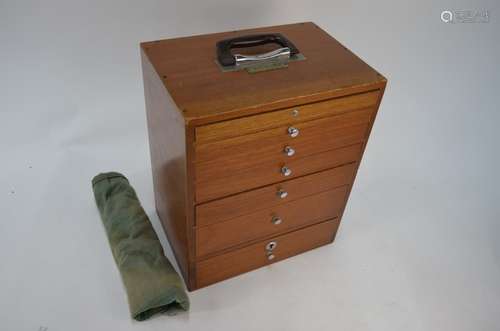 A portable teak dentist's chest of seven graduated drawers