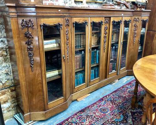 A large Edwardian walnut low library bookcase / cabinet of inverted breakfront form