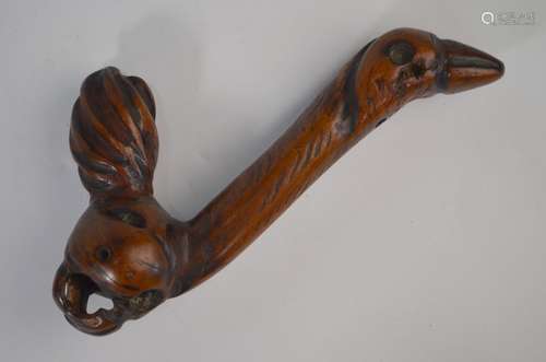 A tribal carved wood suspension hook