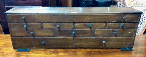 A 19th century table top chest of ten variously arranged drawers