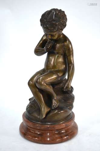 A bronze figure of a contemplative young cherub