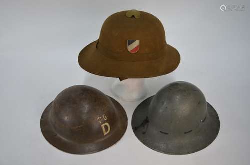 Three World War II helmets