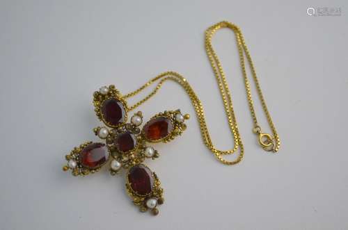 A 19th century Castellani style cross set with oval and square garnets and seed pearls,