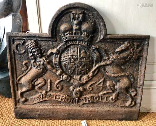 An old cast iron fireback, cast in relief with the Royal cypher of Charles II