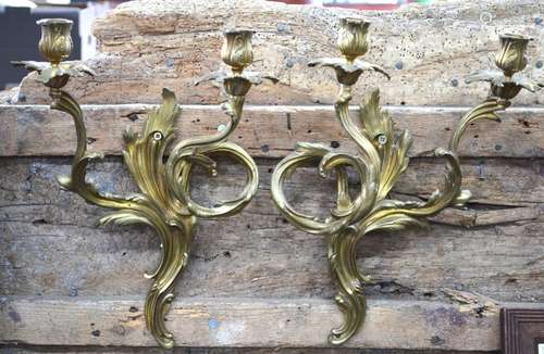 Two pairs of gilt brass twin-branch wall sconces in the Rococo manner