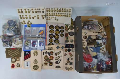 A large collection of embroidered cloth military badges