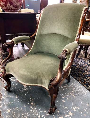 A Victorian mahogany framed green upholstered open salon chair