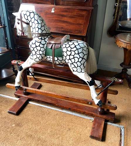 An antique carved wood rocking horse