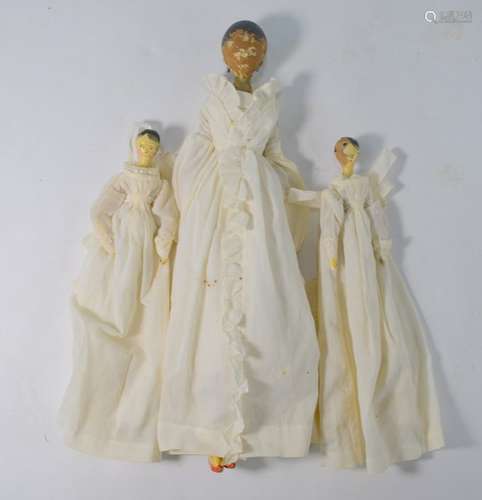 A 19th century German wooden doll and two other smaller dolls