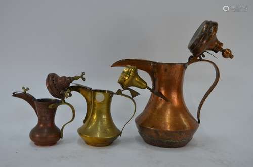 Three Middle Eastern copper and brass coffee pots