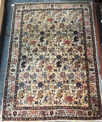 An old Persian Kashan carpet, the floral design on camel ground