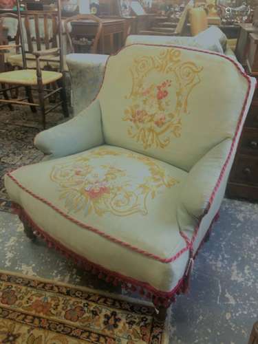 A Victorian low armchair / nursing chair with floral embroidered covers