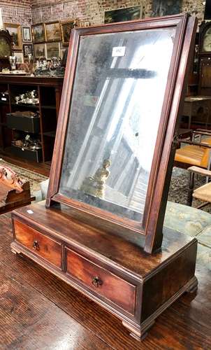 An antique mahogany swing platform mirror