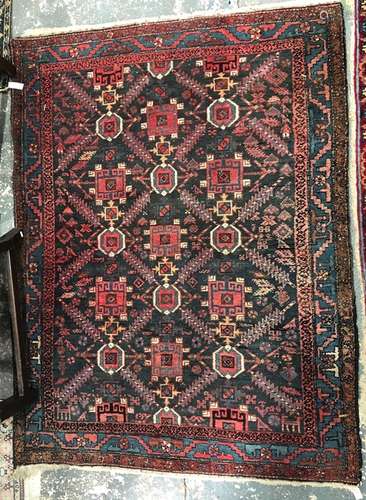 A Persian-Kurd rug, the geometric design on ink-blue ground