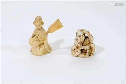 A Japanese carved ivory okimono of a man with a noh mask