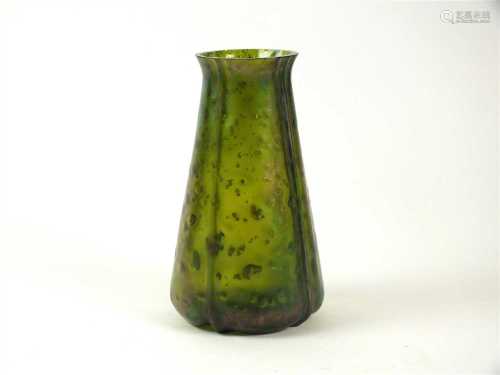 An early 20th century green glass vase in the manner of Loetz