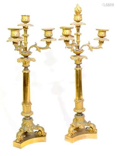 A pair of Charles X gilt bronze candlesticks