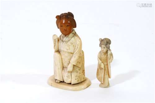 A Japanese carved and stained bone okimono of a geisha