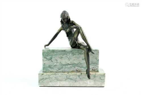 An Art Deco style cast metal figure on a stepped polished marble base