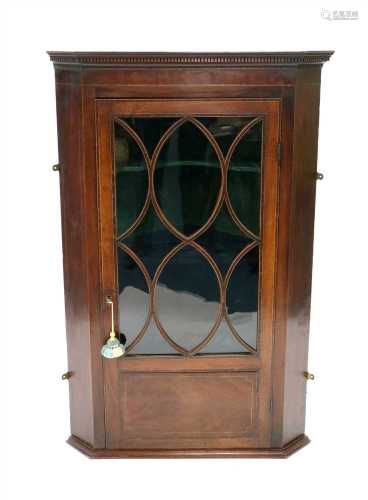 A George III mahogany veneered wall-hanging corner cupboard