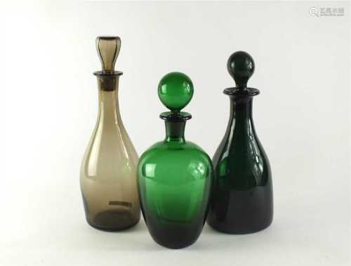 Three glass decanters and stoppers